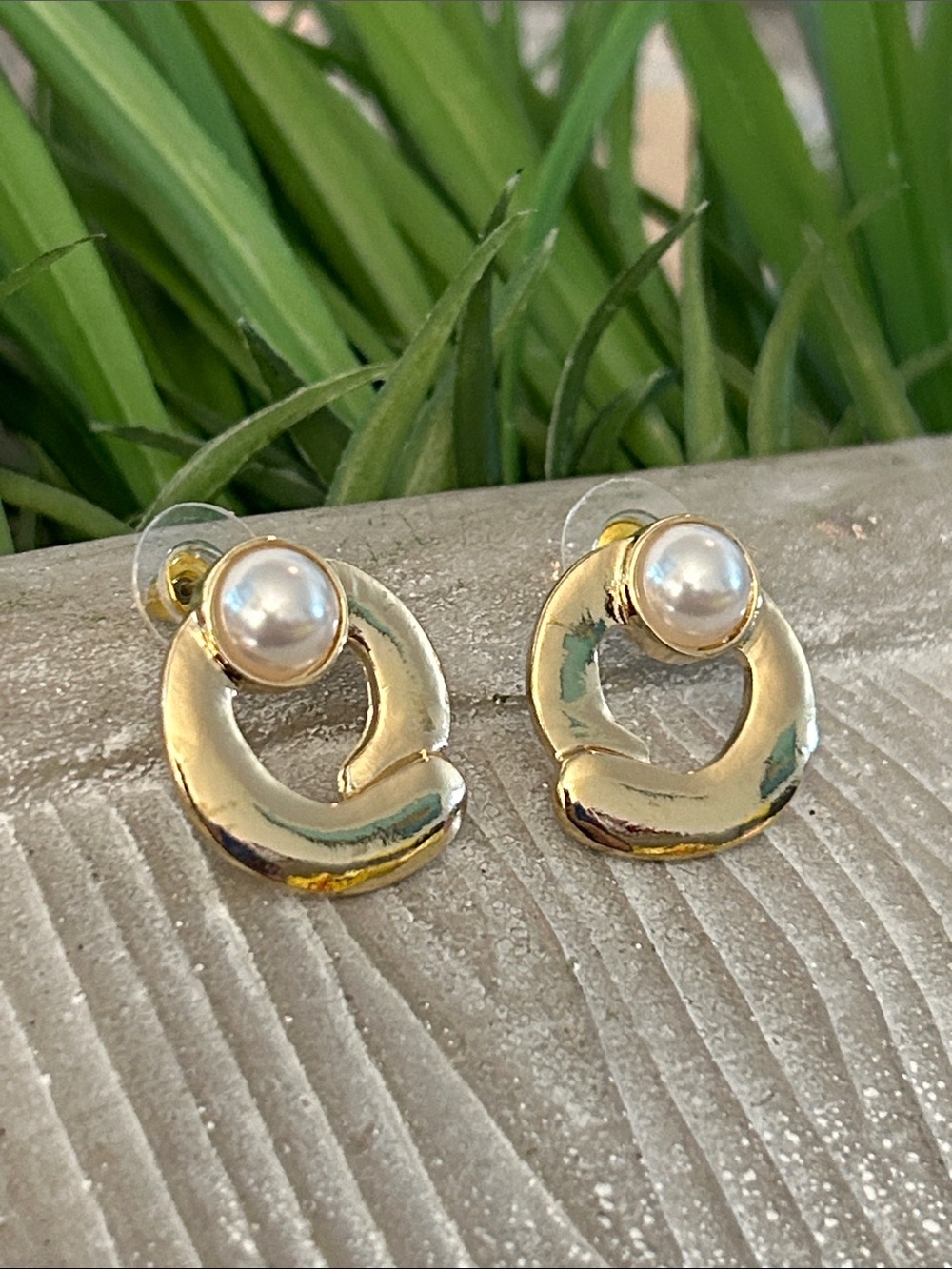 Circular gold-tone sculptural post-back earrings with faux pearl accent